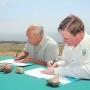 Lopez and Cooper sign the MOU.