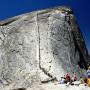 People lined up to climb the last 400 feet of Half Dome. Photo by HylgeriaK on Creative Commons.