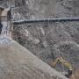 The river flows through a feeding tube lashed to the hillside as the San Clemente Dam is removed.