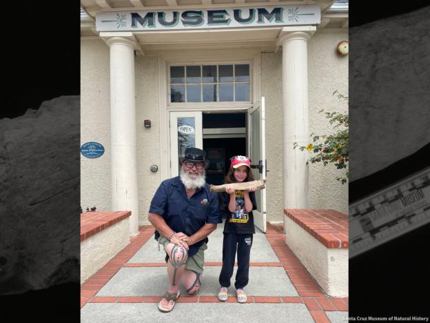 Wayne Thompson with kid in front of the Museum. Courtesy of Santa Cruz Museum of Natural History.
