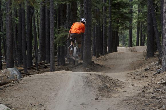 A mountain biker gets airborne. Mountain bikers have long thought sustainable trails might be boring trails. Bell press photo.