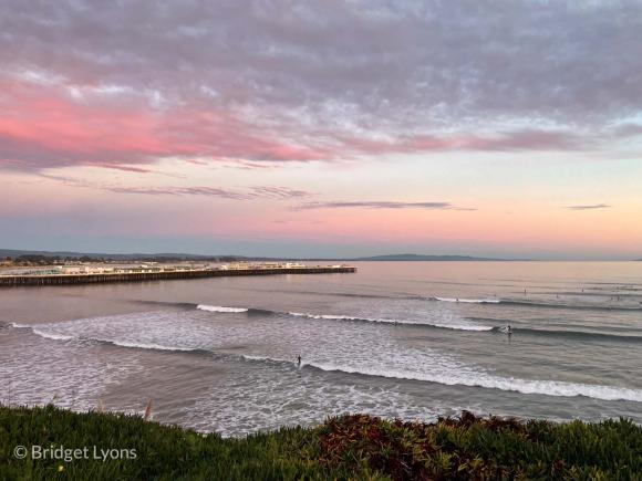 Dawn above the Santa Cruz Wharf and some fortunate surfers at Cowell’s. Photo by Bridget Lyons.