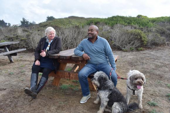 Alex Conway, left, and Gilbert sit with their dogs at Manresa Uplands State Beach--a favorite walking spot for the couple — so much that Conway dedicated a Tribute Table to commemorate their relationship. Photo: FOSCSP
