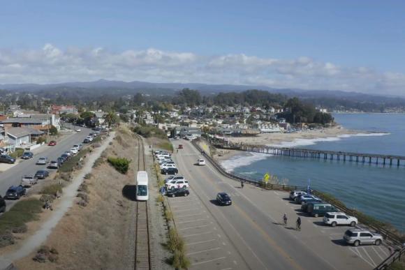 The rail line hugs the coast by the Capitola Wharf. Photo courtesy of Friends of the Rail & Trail.